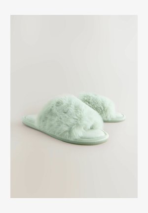 Falske pels hjemmesko i lys mintgrøn, med et blødt bånd over toppen og en flad, glat sål. Blød tekstur med et enkelt design.