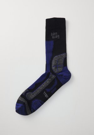 Black sock with blue and gray geometric patterns, ribbed cuff, reinforced toe and heel, branded with "hanwag" and "TREK" text.