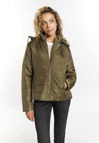 Giacca trapuntata verde oliva con zip frontale, cappuccio e due tasche laterali. Caratterizzata da un tessuto liscio e leggero e da una vestibilità ampia.