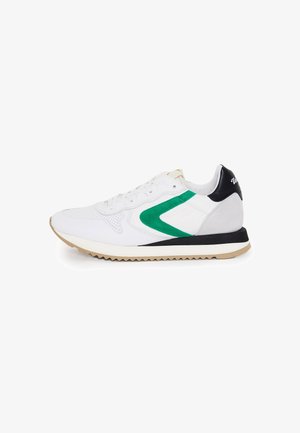 White athletic sneaker featuring a green logo, black heel counter, and textured materials; rubber outsole with a zigzag tread pattern.