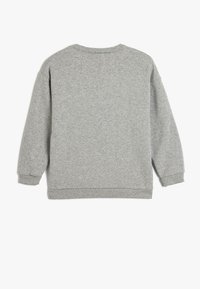 Sudadera gris con cuello redondo, puños y dobladillo de canalé, y una textura suave. Presenta un corte relajado y un diseño mínimo en la parte posterior.