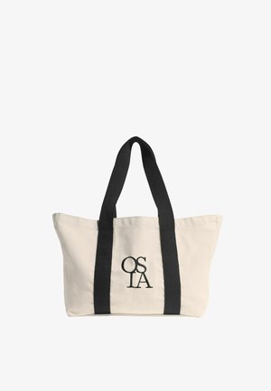 Bolsa tote de lona beige con correas verticales negras y "OSLA" bordado en negro en el centro frontal.