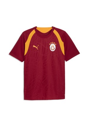 Maroon og gul sportstrøje med korte ærmer med Puma-logo på højre bryst og Galatasaray fodboldklubemblem på venstre bryst.