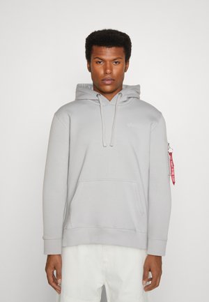 Gray hooded sweatshirt with a front pocket, ribbed cuffs, and a zipper pocket on the left sleeve featuring a red fabric tag.