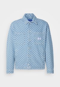 Light blue button-up jacket featuring a checkerboard pattern, two front pockets, and a branded label on the left pocket. Cotton material.