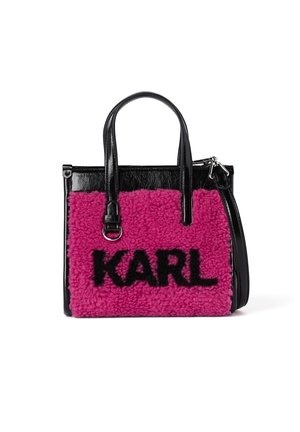 Black and pink handbag with black patent leather handles and "KARL" in bold black letters on fuzzy pink fabric panel.