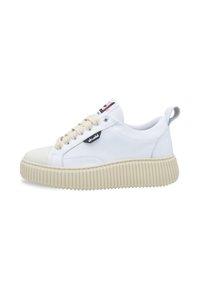 White leather sneaker with a rounded toe, textured beige rubber sole, and cream laces, featuring a small logo patch on the side.