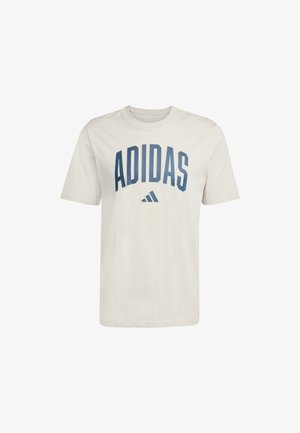 Tricou din bumbac de culoare crem, cu un logo mare albastru "ADIDAS" pe piept și emblema celor trei dungi dedesubt. Mâneci scurte, guler rotund.