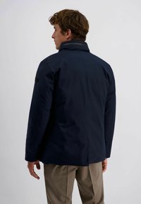 Navyblauwe geïsoleerde jas met een hoge kraag, platte naden en zijzakken, gemaakt van gladde stof; achteraanzicht weergegeven.