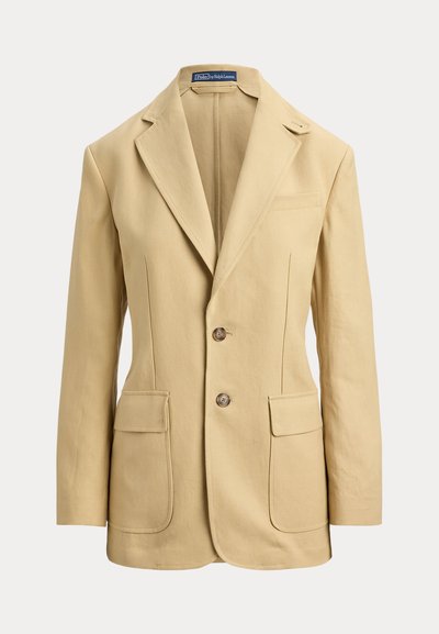 Μπεζ λινό σακάκι με γιακά με χαραγμένο έντομο, κλείσιμο με δύο κουμπιά, δύο μπροστινές τσέπες και μία τσέπη στο στήθος. Λείο ύφασμα, εφαρμοστή γραμμή.