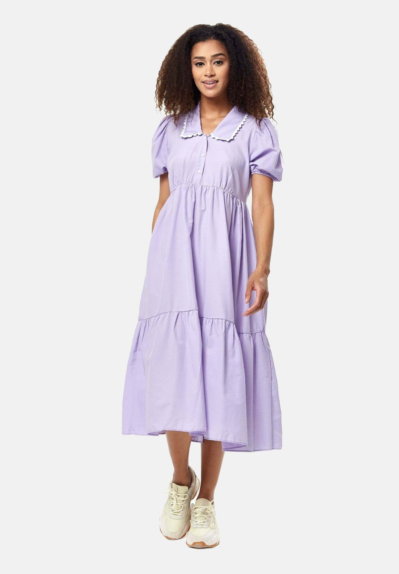 Lavender midi dress featuring puff sleeves, a buttoned front, and a contrasting collared neckline. Flowy tiered skirt with a soft texture.