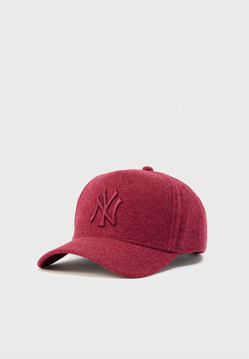 Gorra de lana roja con visera curva y bordado en relieve del logo de los New York Yankees en la parte frontal. Textura suave y diseño sin costuras.