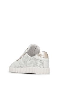 White sneaker with a perforated texture, light gold accents, cushioned collar, and a textured rubber sole.