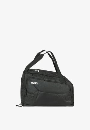 Schwarze, weiche Stoff-Reisetasche mit zwei Schulterriemen und einer seitlichen Reißverschlusstasche, mit dem Markenlogo "evoc" in weißem Text.