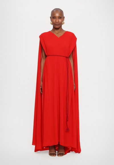 Red chiffon dress with a V-neck, caped sleeves, and a waist belt. The fabric drapes elegantly, featuring a smooth texture and side slits.