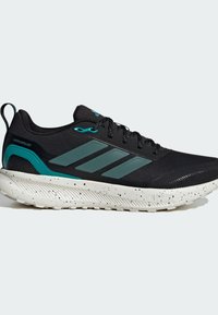 Zapatillas deportivas negras con parte superior repelente al agua, detalles en verde azulado, diseño de tres rayas, suela texturizada con motas, construcción ligera.