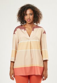 Blusa ligera de manga larga con escote en V, con rayas horizontales en beige, naranja y blanco. Tejido suave con un corte relajado.