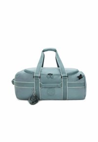 Sac de sport teal avec courtes poignées, fermeture zippée et accents blancs. Présente un logo rond et un porte-clés avec pompon détachable.