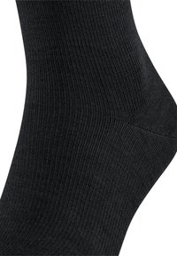 Black ankle sock featuring a ribbed texture and smooth finish, designed for comfort and durability.
