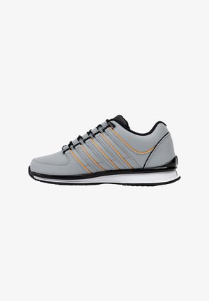 Gray athletic shoe featuring synthetic upper, black accents, orange stripes, rubber sole, and lace-up design. Rounded toe and cushioned collar.