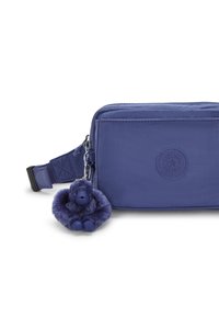 Purple nylon crossbody bag with a textured finish, featuring a zip closure and a plush monkey charm attached to the zipper.