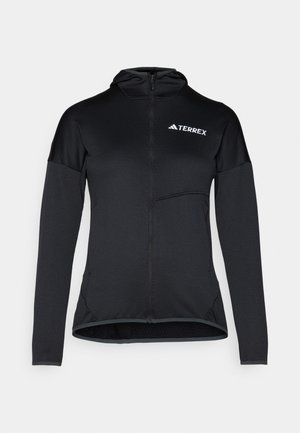 Hoodie Terrex noir avec fermeture éclair intégrale, manches longues et petite poche poitrine ; fabriqué à partir d'un tissu léger et lisse avec un design ajusté.