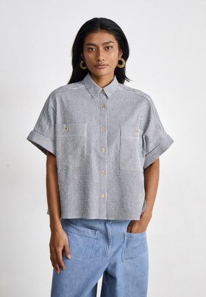 Short-sleeve, collared shirt with blue and white vertical stripes, featuring two front pockets and golden buttons. In a relaxed fit.
