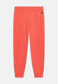 Coral sweatpants made of soft fabric, featuring an elastic waistband, cuffed ankles, and a small logo on the left thigh.