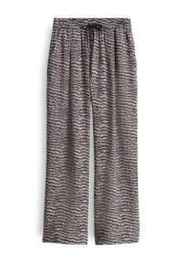 Pantalon ample à jambes droites avec un motif de points irréguliers noir et blanc et un cordon noir à la taille élastique.