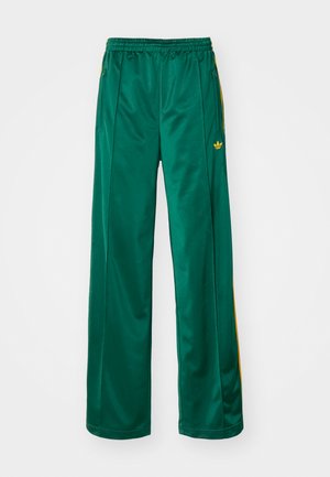Green satin athletic pants with a relaxed fit, featuring yellow stripe accents and an embroidered logo on the left side. Elastic waistband.
