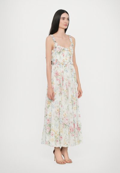 Bloemenmaxi-jurk met een smockbustier, dunne bandjes met bloemenaccenten en een luchtige, lichte stof in pastelkleuren.