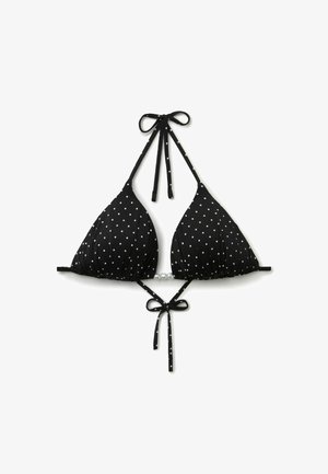 Top de bikini negro con lunares blancos, cuello halter y tiras delanteras para atar la espalda, mostrado plano sobre un fondo blanco.