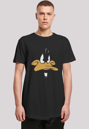 Black cotton t-shirt featuring a large yellow and white graphic of a cartoon duck's face, with expressive eyes and details on the beak.