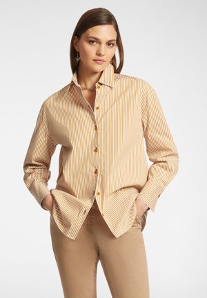 Striped button-up shirt in yellow and cream, with a classic collar and long sleeves. Features brown buttons and a relaxed fit.