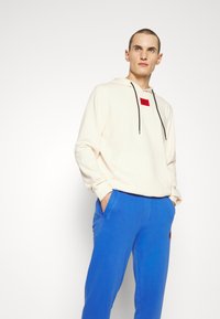 HUGO DARATSCHI - Sweatshirt com capuz - natural