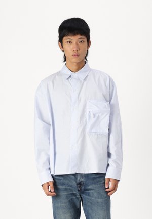 Blue and white striped shirt with a collar, front pocket, and button closure. Long sleeves, relaxed fit, made from lightweight fabric.