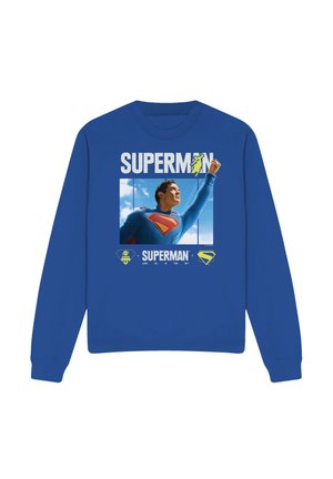 Blue sweatshirt with Superman flying upward graphic, bold "SUPERMAN" text, and logos including the "S" shield and text "Look up in the sky."