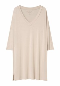 Beżowa, oversize koszulka z dekoltem w serek, krótkimi rękawami i bocznymi rozcięciami. Wykonana z lekkiego, miękkiego materiału o gładkiej strukturze.