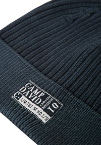 Dark gray knitted beanie with a ribbed texture. Features a white label with "CAMP DAVID," "LIMITED," and reference number "10" stitched on it.