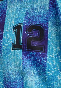 Blå och lila mönstrad sporttröja med siffran "12" i svart, med en texturerad tyg och en livlig färggradient.