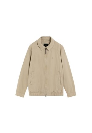 Chaqueta ligera beige con cremallera frontal, dos bolsillos laterales, dobladillo elástico y cuello clásico, extendida sobre fondo blanco.