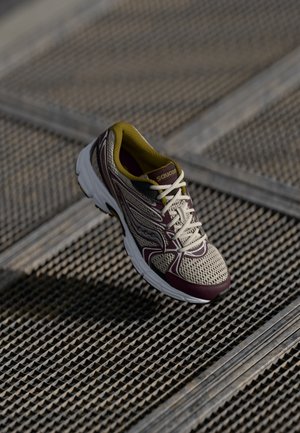 Laufschuh mit einem beigen Mesh-Obermaterial, bordeauxfarbenen Akzenten und einer gepolsterten weißen Sohle. Verfügt über eine Schnürung und eine strukturierte Außensohle.