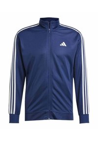 Giacca zip-up blu marina realizzata in tessuto liscio, caratterizzata da accenti in bianco con tre strisce sulle maniche e un piccolo logo bianco sul petto.