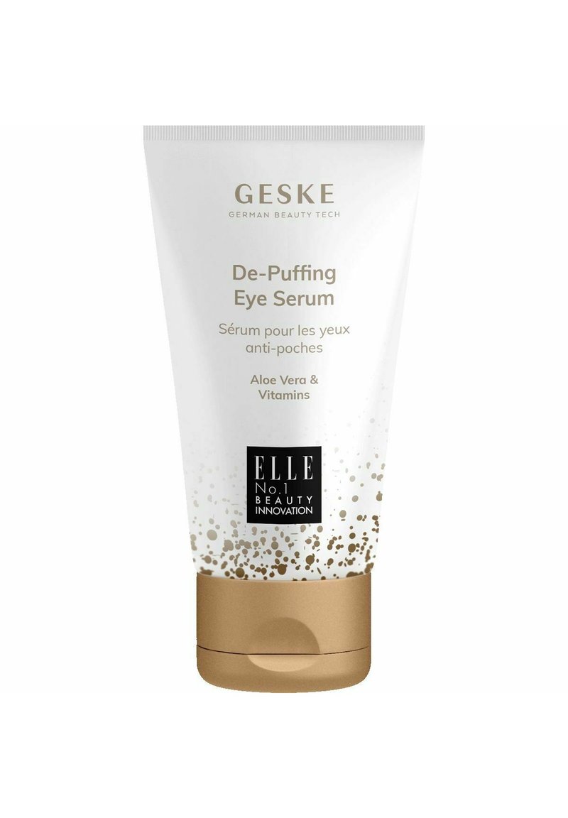 Tubo di siero de-puffing per gli occhi con corpo bianco lucido, accenti dorati e design testurizzato. L'etichetta include ingredienti: Aloe Vera e Vitamine.