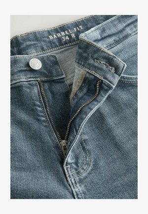 Lys blå denim jeans med et "Barrel Fit" label. Har en metalknap og lynlåslukning. Stoffet har en let tekstureret overflade.