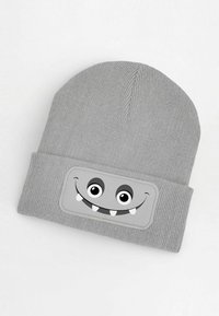 Gray knit beanie featuring a stitched patch with a cartoon monster face, including two large eyes and two prominent teeth.