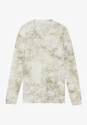 Dlhý rukáv v svetlej béžovej farbe s tie-dye vzorom v tmavších odtieňoch. Má okrúhly výstrih a malé logo na hrudi. Mäkká textúra.