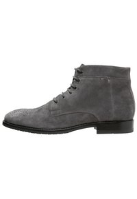 Gray suede lace-up ankle boot with brogue perforation on toe and a black low heel sole.