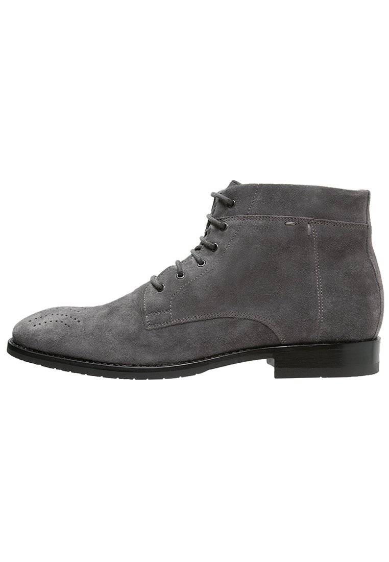 Gray suede lace-up ankle boot with brogue perforation on toe and a black low heel sole.