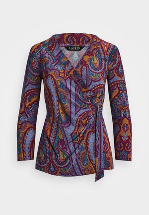 Mnohobarvna paisley bluza z dolgimi rokavi, globokim V-izrezom in zavojem. Ima vijolične, modre in zlate vzorce na mehkem materialu.